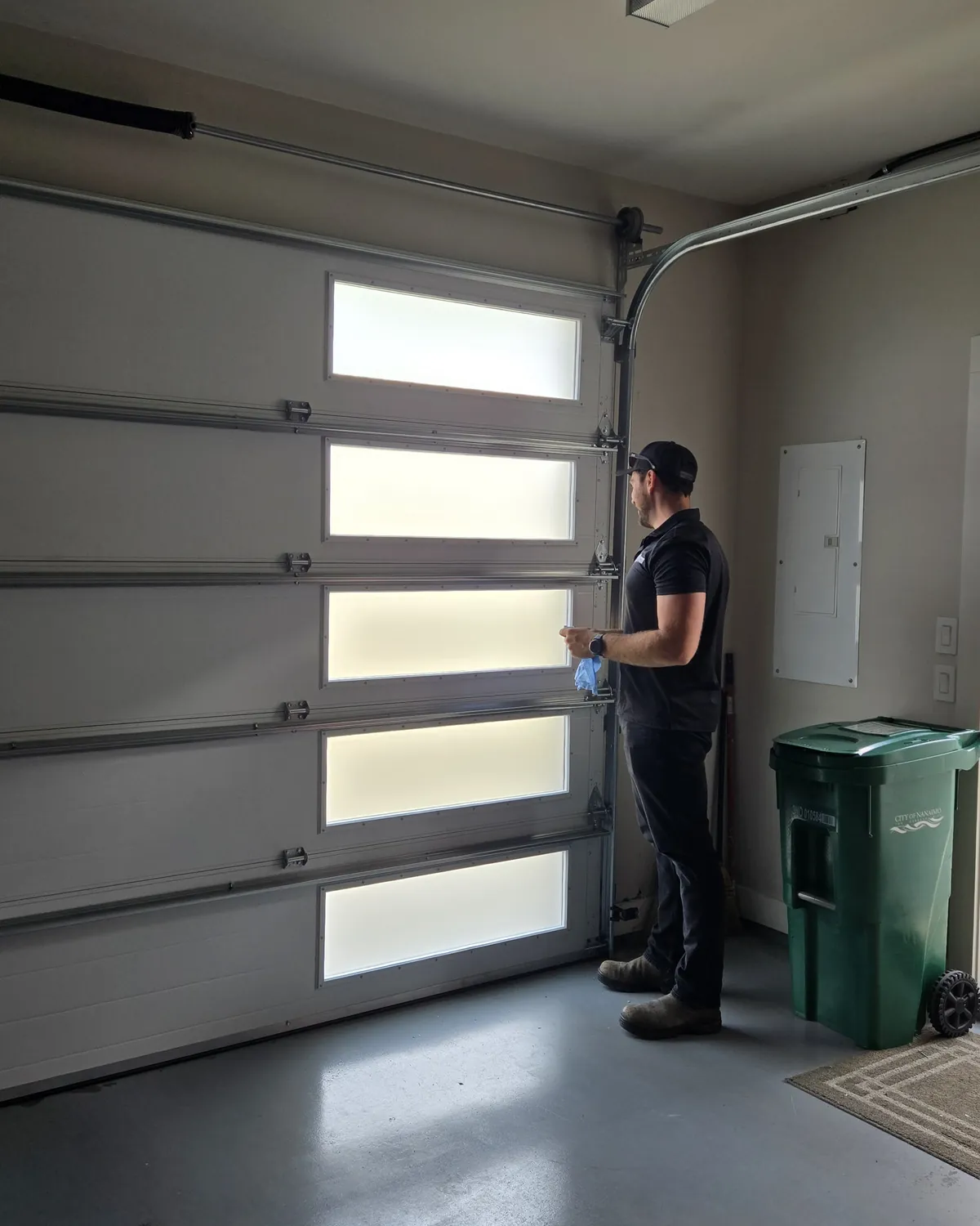 Garage Door Doctor Canada technician checking the operation of a garage door from inside a Nanaimo garage