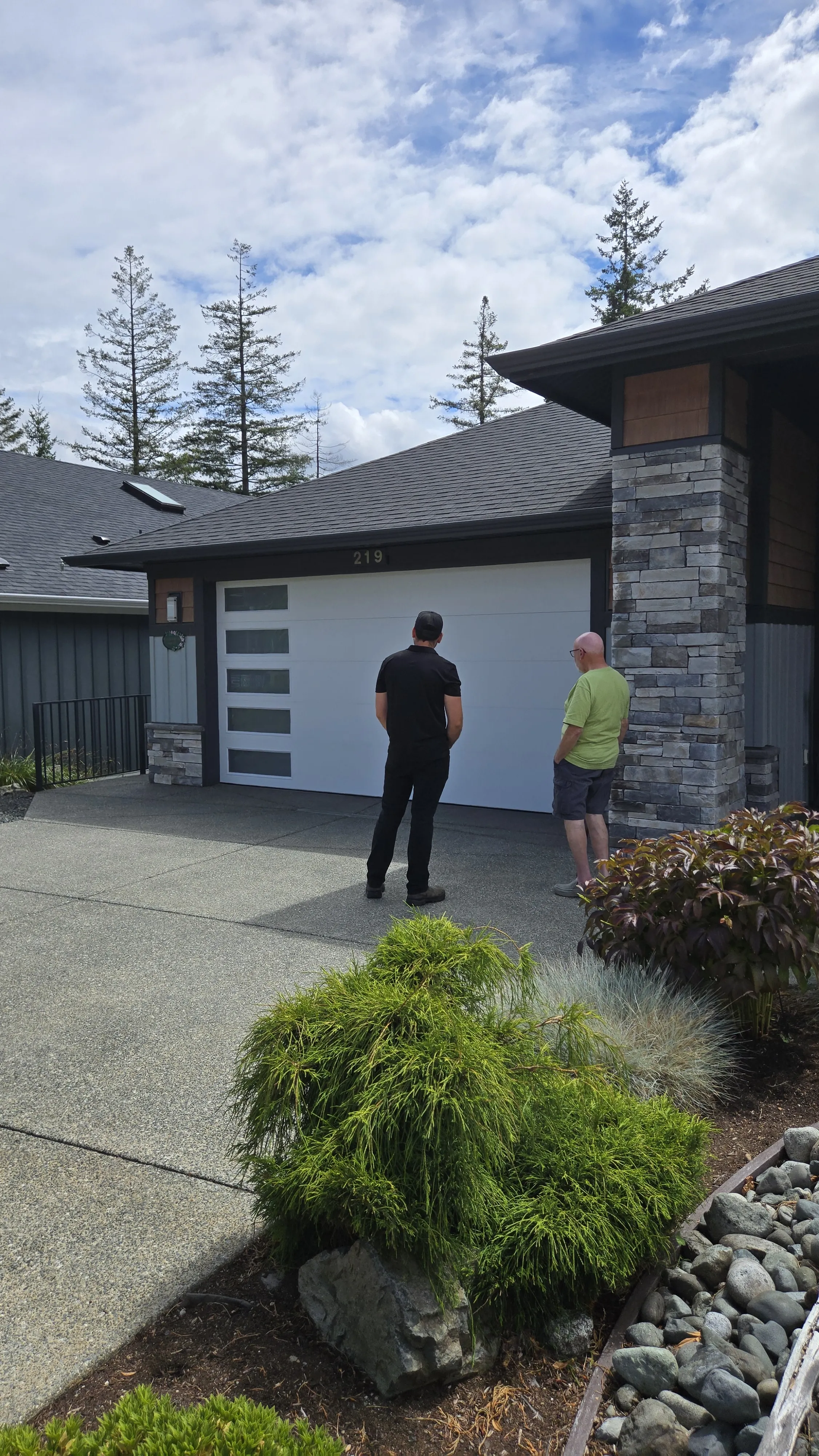 Garage Door Doctor co-owner Mark with a customer beside a newly installed garage door