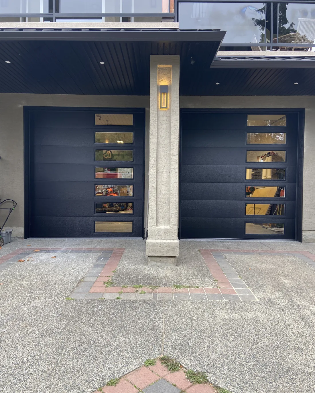 Two new dark Hormann Therma Tech 3400 garage doors with stacked glazing, installed on a Departure Bay home in Nanaimo
